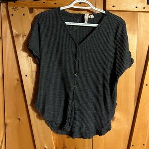 Short sleeve grey button up t-shirt.